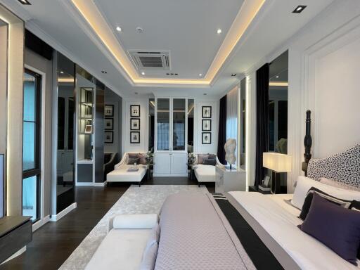 Spacious modern bedroom with ambient lighting and elegant decor