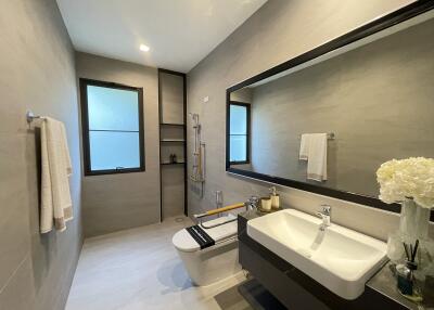Modern bathroom with large mirror and well-lit vanity area