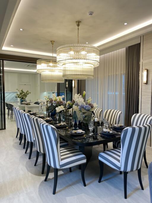 Elegant dining room with modern striped chairs and a large chandelier