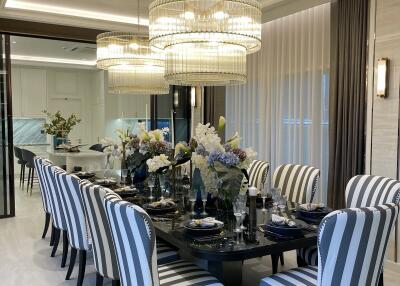 Elegant dining room with modern striped chairs and a large chandelier