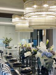 Elegant dining room with grand chandeliers and sophisticated table setting