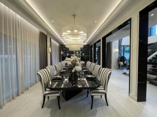 Elegant dining room with modern chandelier and black dining table