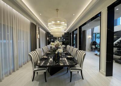 Elegant dining room with modern chandelier and black dining table