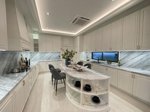 Modern kitchen with marble countertops and island