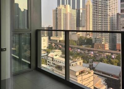 High-rise apartment room with floor-to-ceiling window offering cityscape views