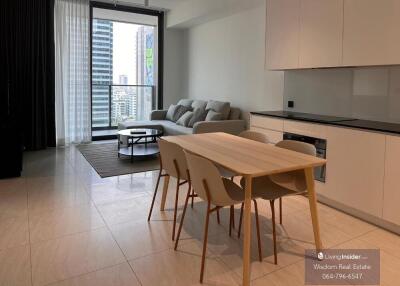 Modern apartment open plan living and kitchen space with balcony access