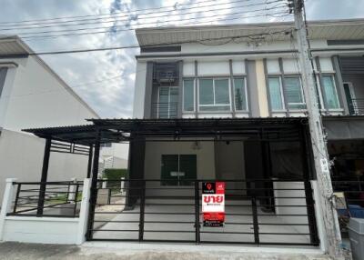 Modern two-story residential building exterior with for sale sign