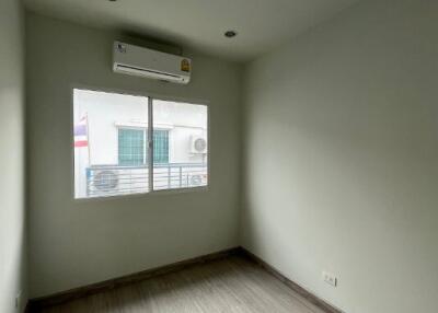 Empty bedroom with air conditioning and natural light