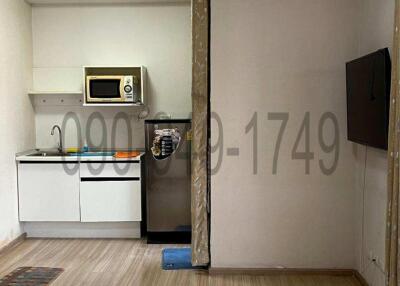 Compact kitchen space with modern appliances and tiled flooring