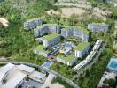 Aerial view of a residential apartment complex surrounded by greenery