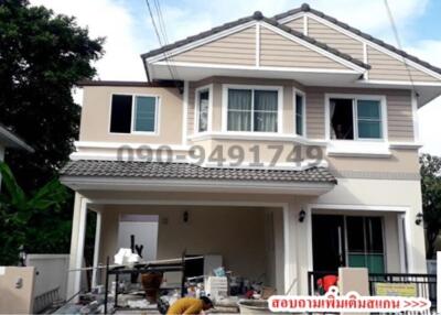 Two-story residential house with a gable roof and a front porch