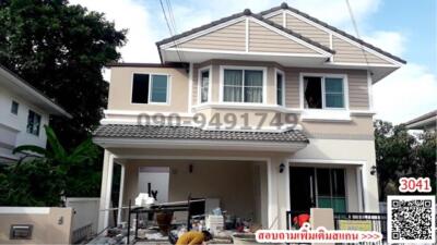 Two-story residential house with a gable roof and a front porch