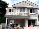 Two-story residential house with a gable roof and a front porch