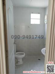 Compact bathroom with toilet and small window
