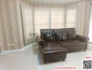 Spacious and elegantly furnished living room with natural light