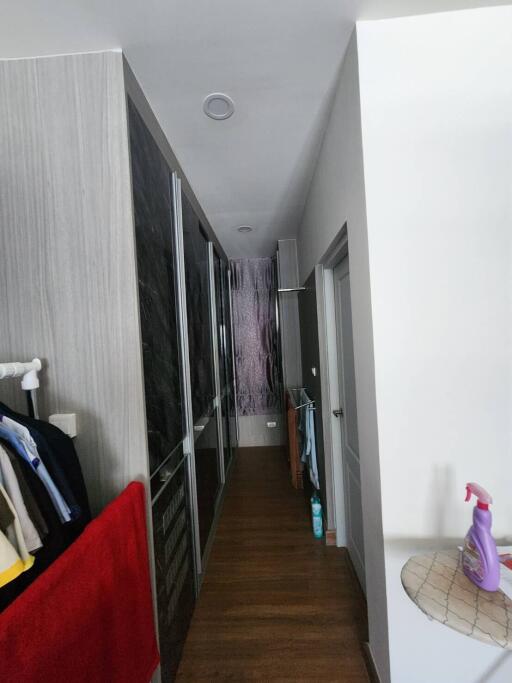 Modern hallway interior with wood flooring and built-in wardrobes