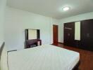 Spacious bedroom with double bed and wooden furniture