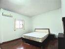 Spacious Bedroom with Large Window and Air Conditioning