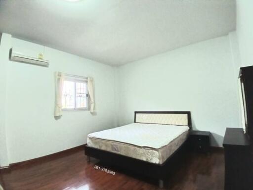 Spacious Bedroom with Large Window and Air Conditioning