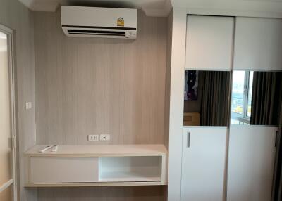 Compact and modern bedroom with air conditioning and ample storage space