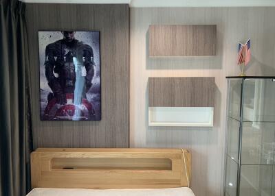 Modern bedroom with a wall-mounted poster, wooden bed frame, and floating shelves
