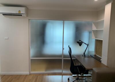 Home office with desk, chair, and built-in shelving units