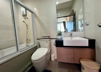 Modern bathroom interior with shower and large mirror