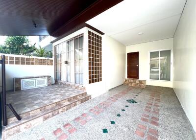 Spacious and covered patio with tiled flooring and large windows