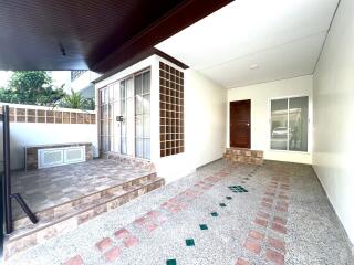 Spacious and covered patio with tiled flooring and large windows