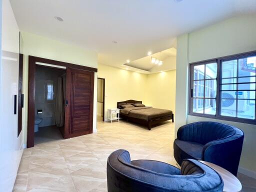 Spacious bedroom with en-suite bathroom and modern furnishings