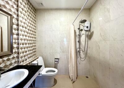 Modern bathroom with geometric tile design and clean amenities