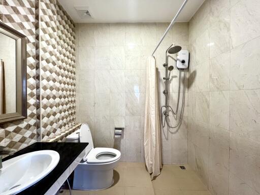 Modern bathroom with geometric tile design and clean amenities