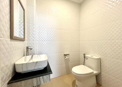 Modern bathroom with white tiles and natural light