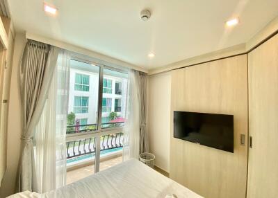 Cozy bedroom with natural light and a balcony