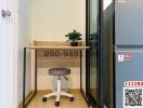 Compact home office space with a wooden desk and rolling office chair