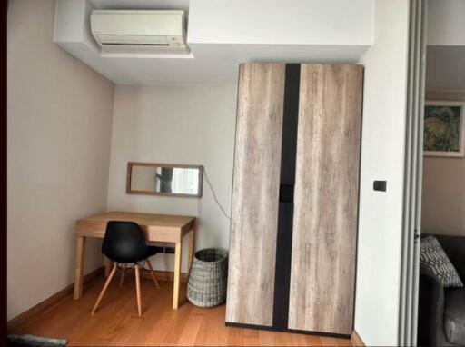 Modern bedroom with wooden furniture and air conditioning unit