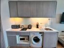 Compact modern kitchen with appliances and cabinets