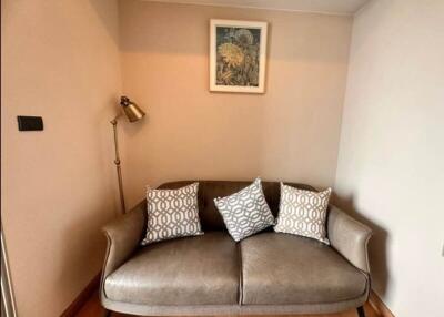 Cozy corner in a living room with a comfortable sofa and a decorative painting