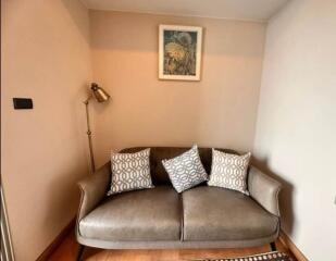 Cozy corner in a living room with a comfortable sofa and a decorative painting