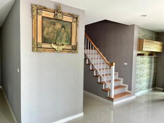 Elegant hallway with staircase and framed artwork