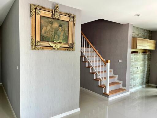 Elegant hallway with staircase and framed artwork