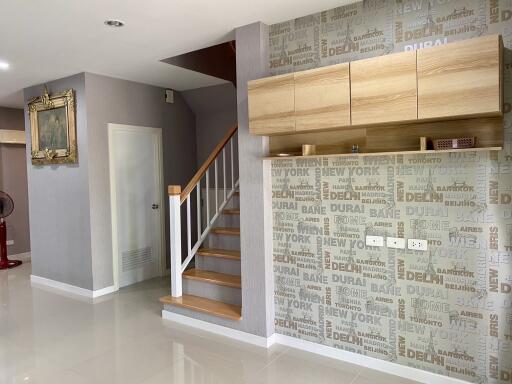 Contemporary home interior with staircase and decorative wallpaper