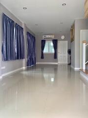 Spacious living room with tiled flooring and large windows