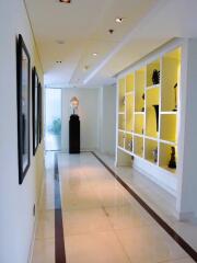 Bright and modern corridor with artistic decorations and recessed lighting