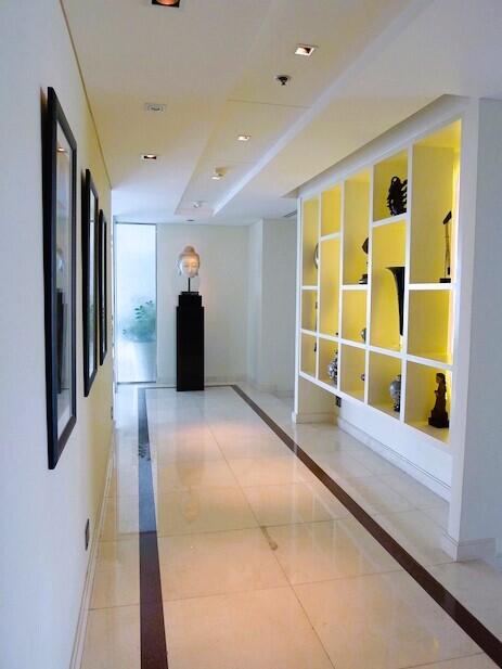 Bright and modern corridor with artistic decorations and recessed lighting