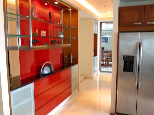 Modern kitchen with red and white cabinets and stainless steel appliances