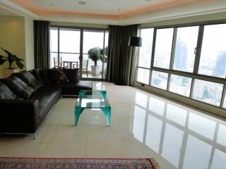 Spacious living room with large windows and city view