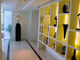 Elegantly decorated hallway with illuminated display shelves