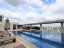Luxurious rooftop swimming pool with city view and lounge chairs