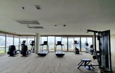 Spacious fitness center with modern equipment and city view